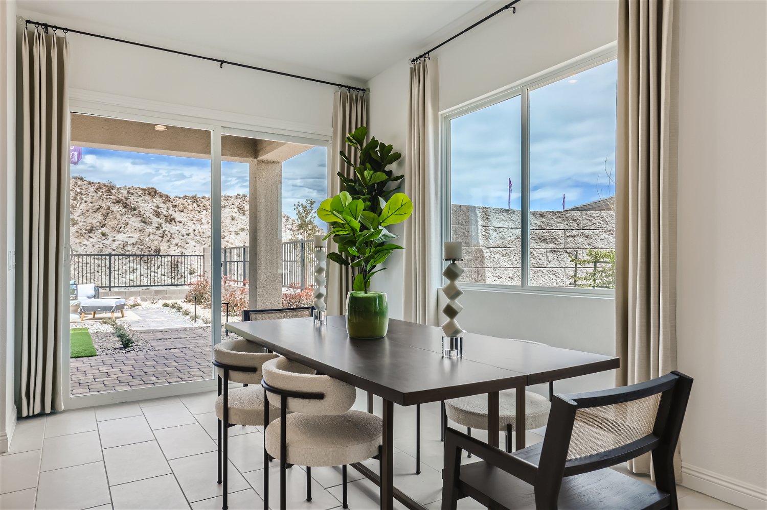 A dining table with chairs and a view of a city.