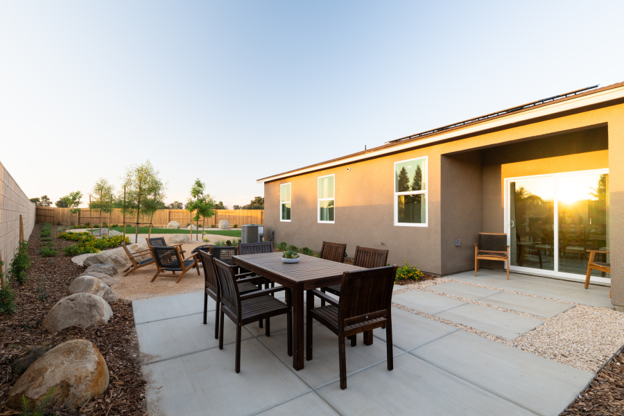 A patio with a table and chairs.