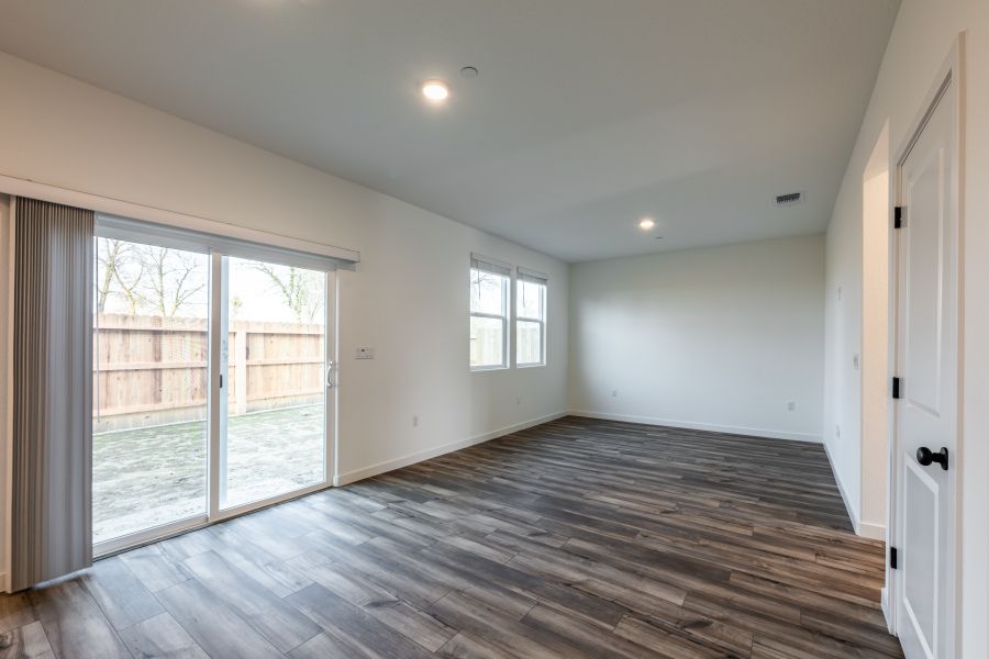A room with a wood floor and windows.