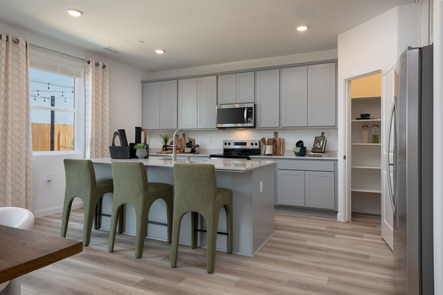 A kitchen with white cabinets.