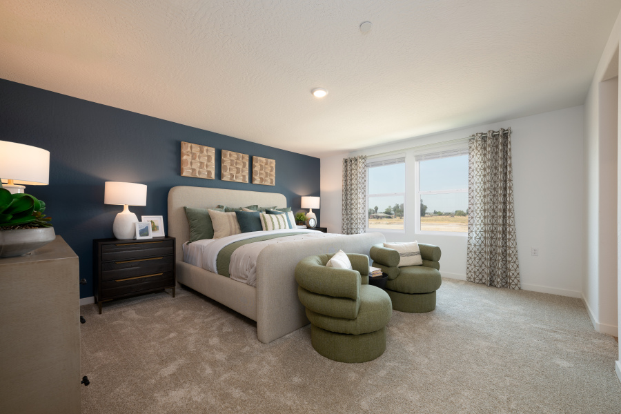 A bedroom with a bed and a couch.