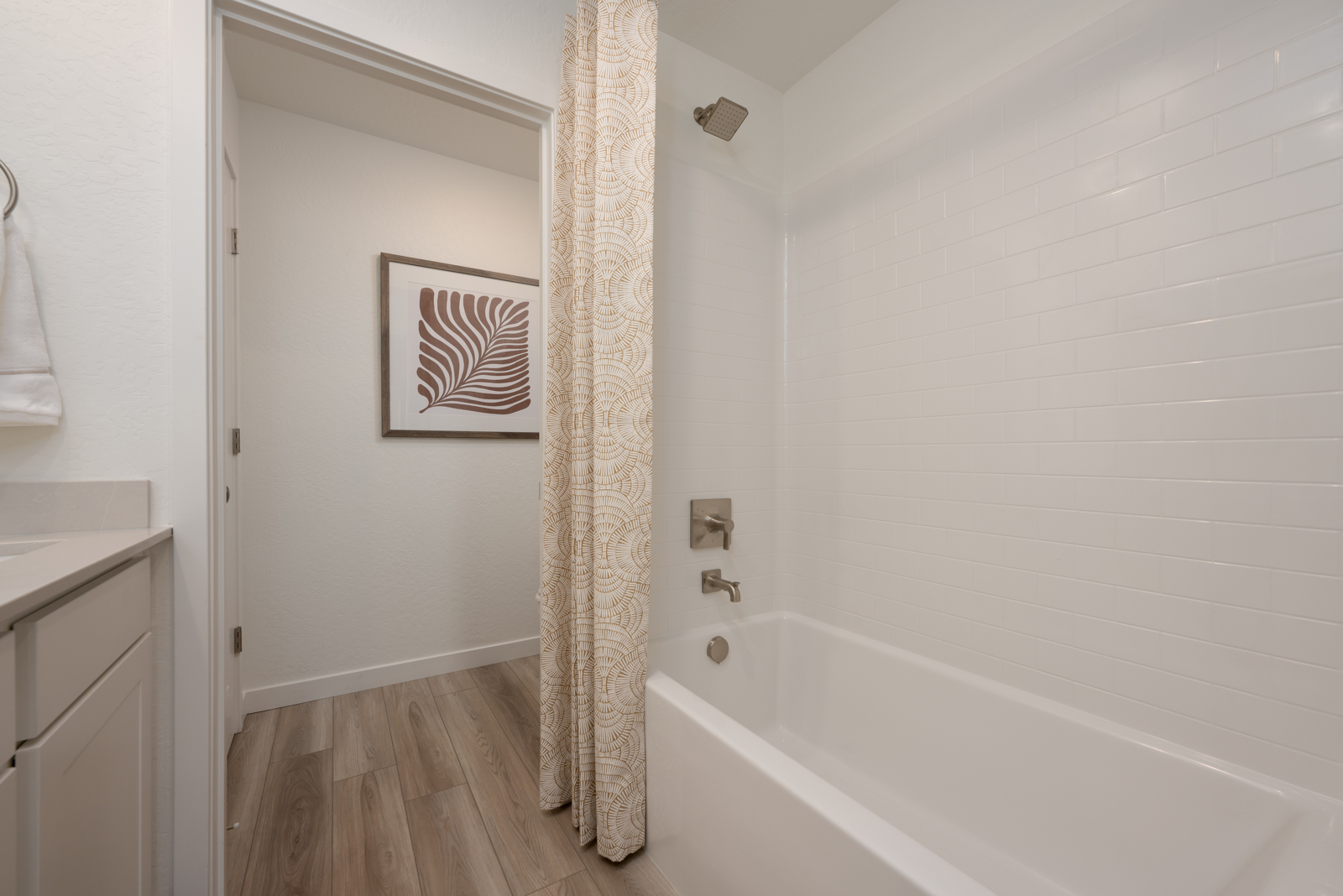 A bathroom with a bathtub and a shower curtain.