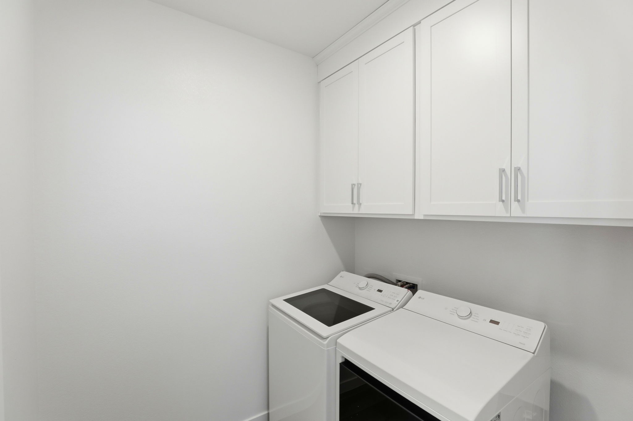 A white kitchen with white cabinets.