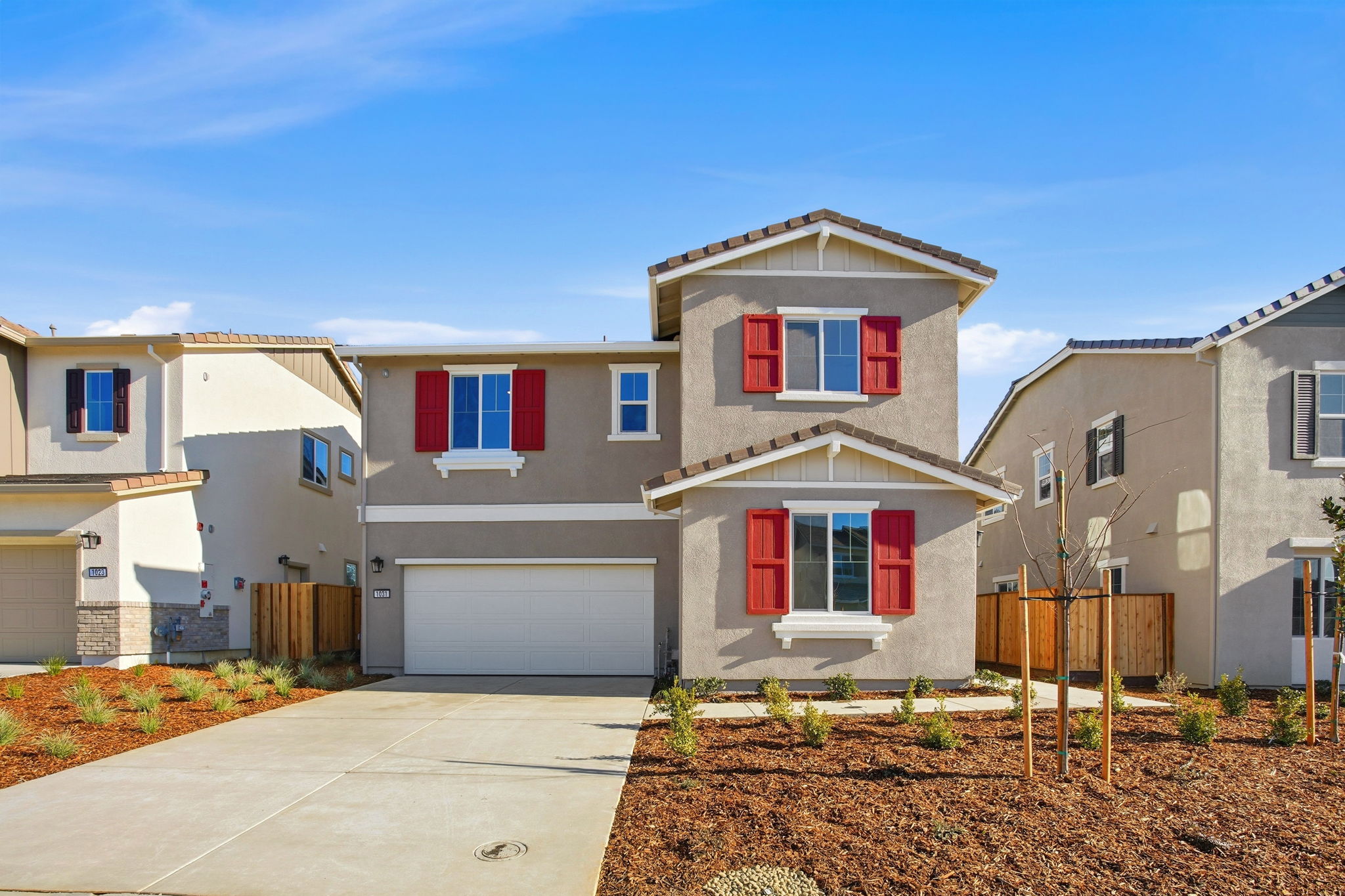 A white house with red shutters.
