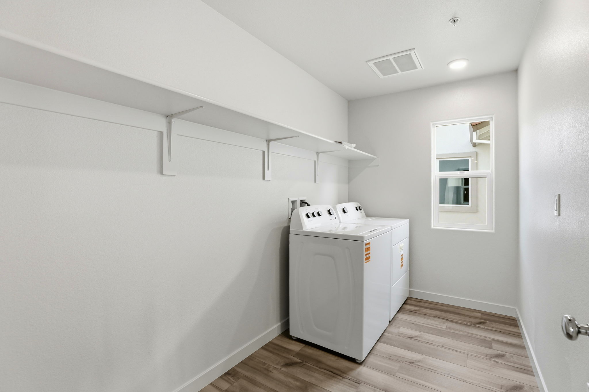 A white room with a washer and dryer.