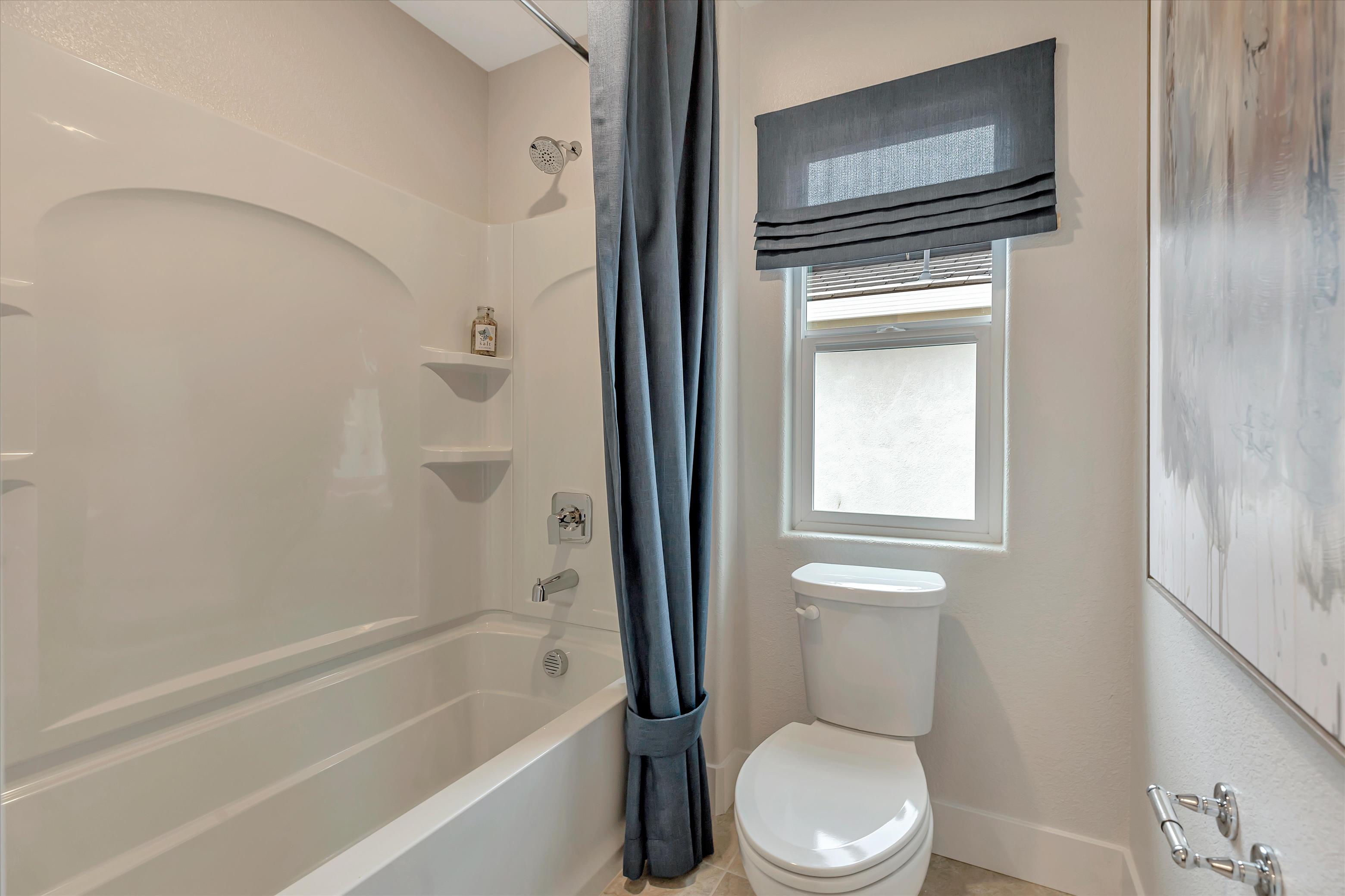 A bathroom with a tub toilet and sink.