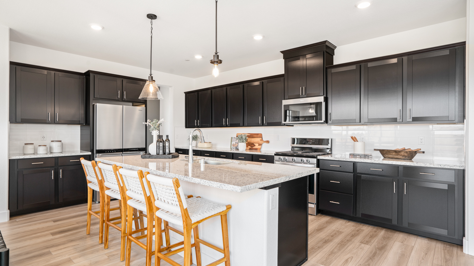 A kitchen with black cabinets.