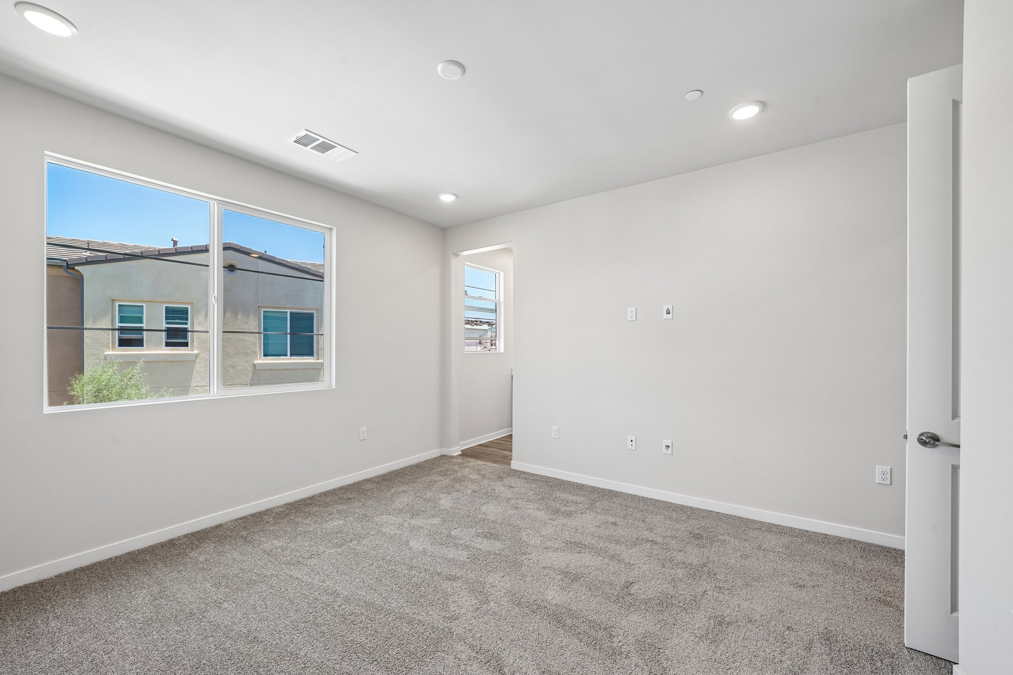 A room with a window and a door.