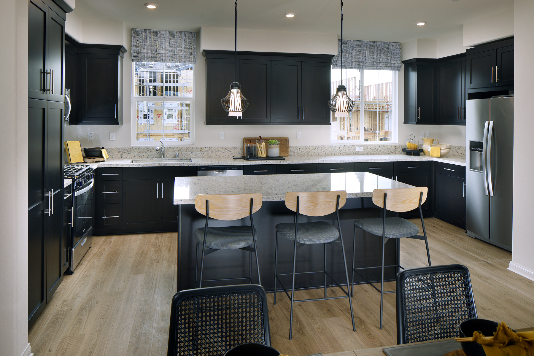 A kitchen with black cabinets.