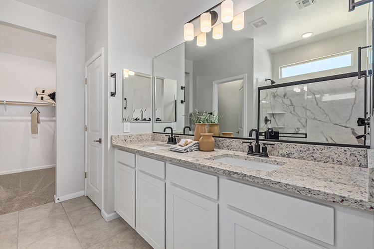 A bathroom with a large mirror.