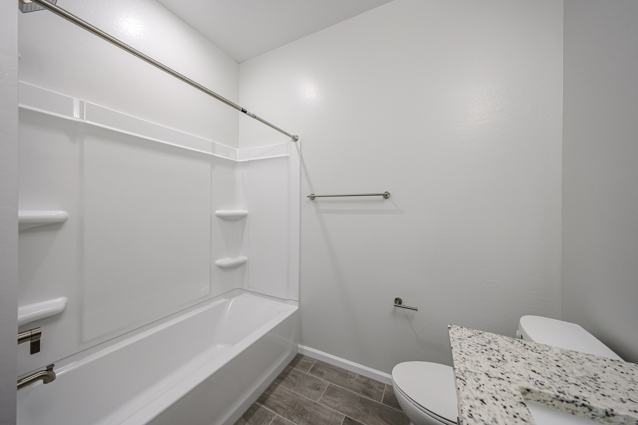 A bathroom with a bathtub toilet and shower.