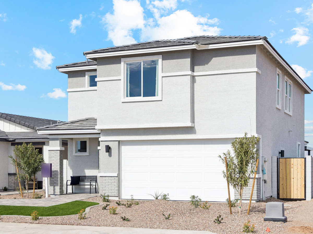 A white house with a garage.