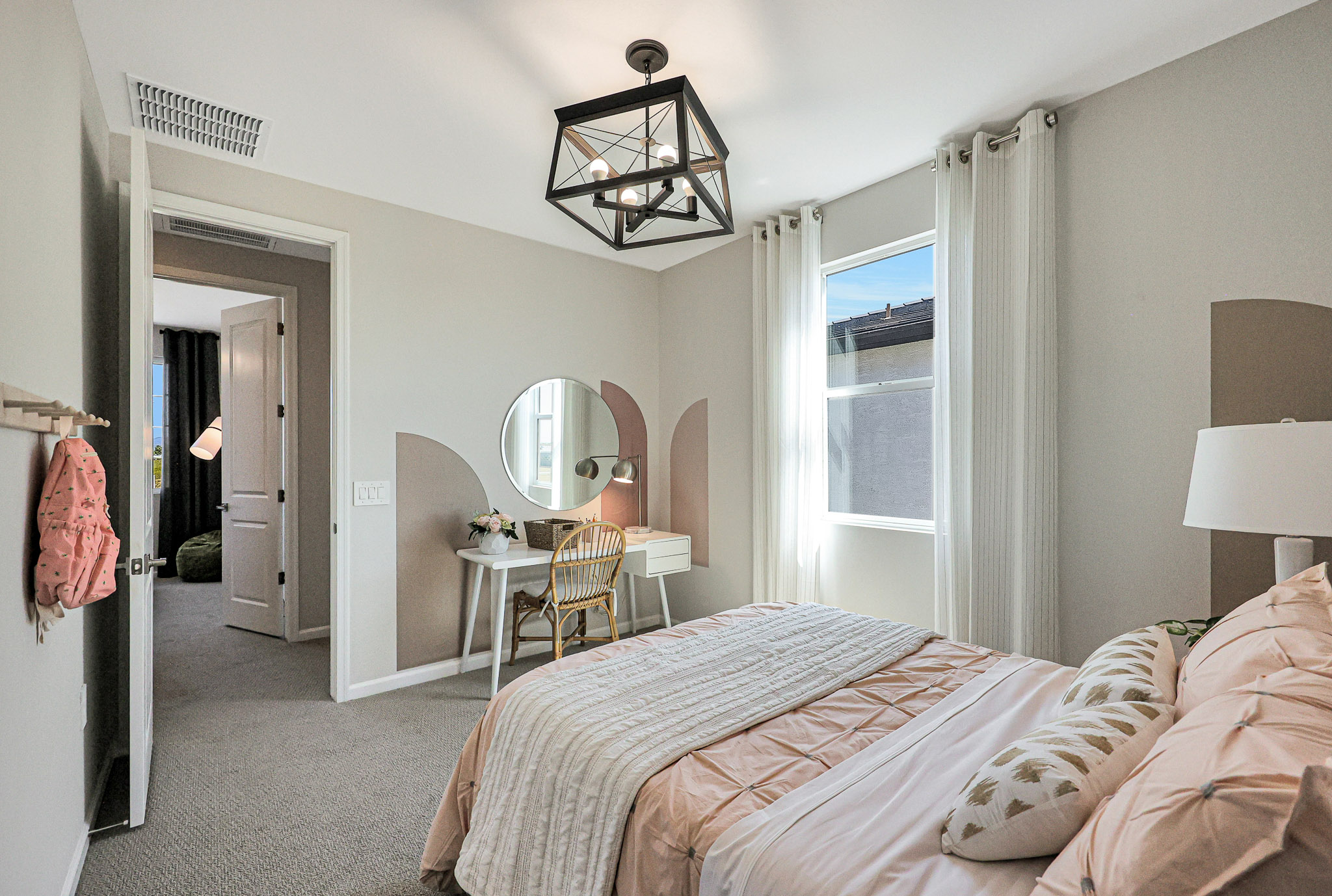 A bedroom with a large mirror.