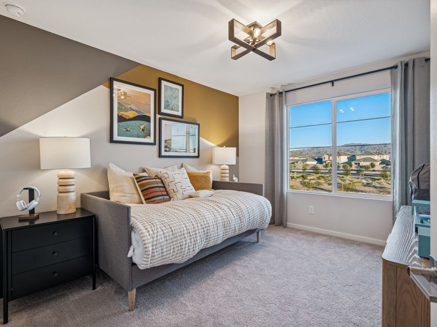 A bedroom with a large window.