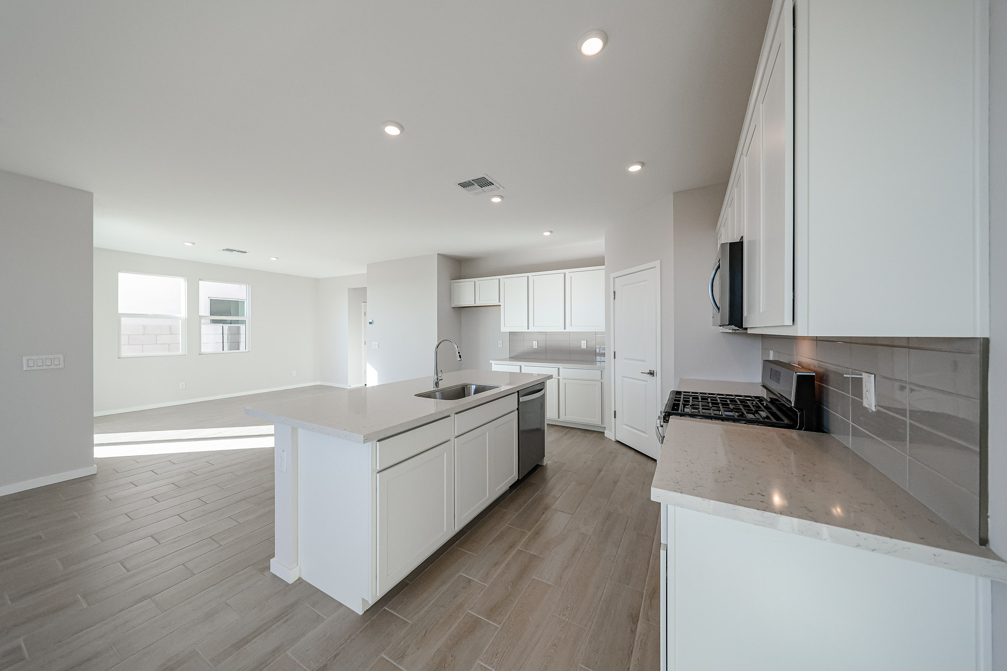 A kitchen with white cabinets.
