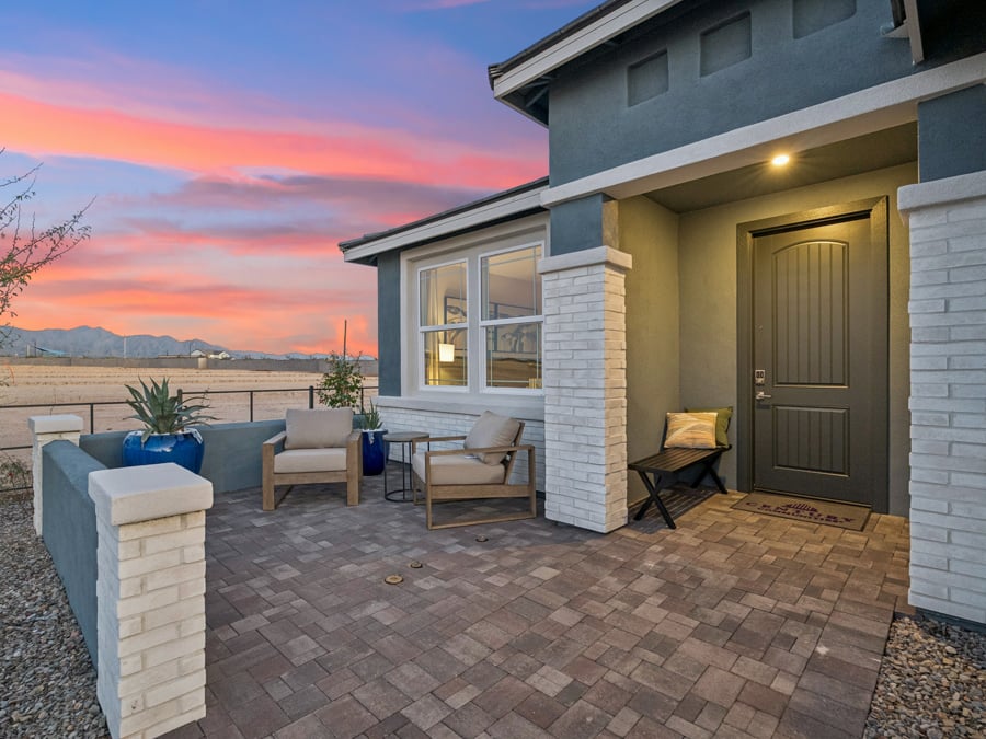 A patio with chairs and a table.