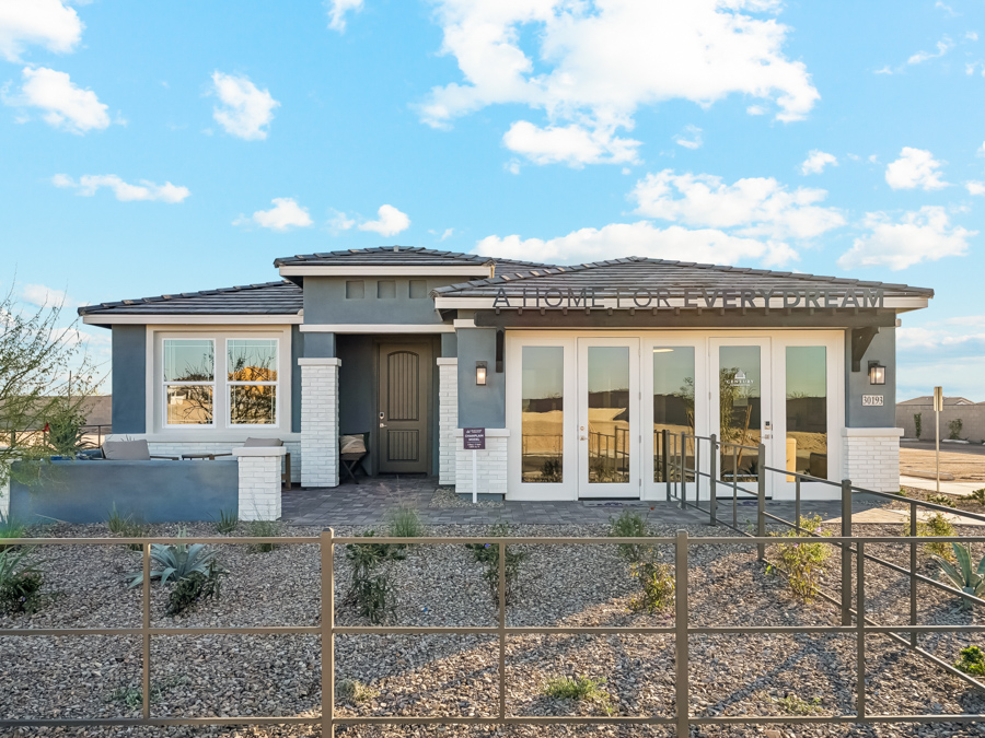 A house with a fence in front.