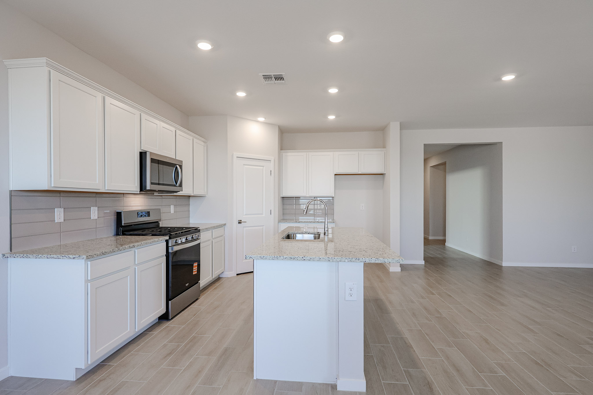 A kitchen with white cabinets.