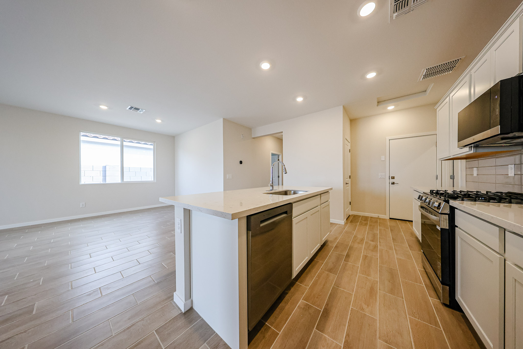 A kitchen with a wood floor.