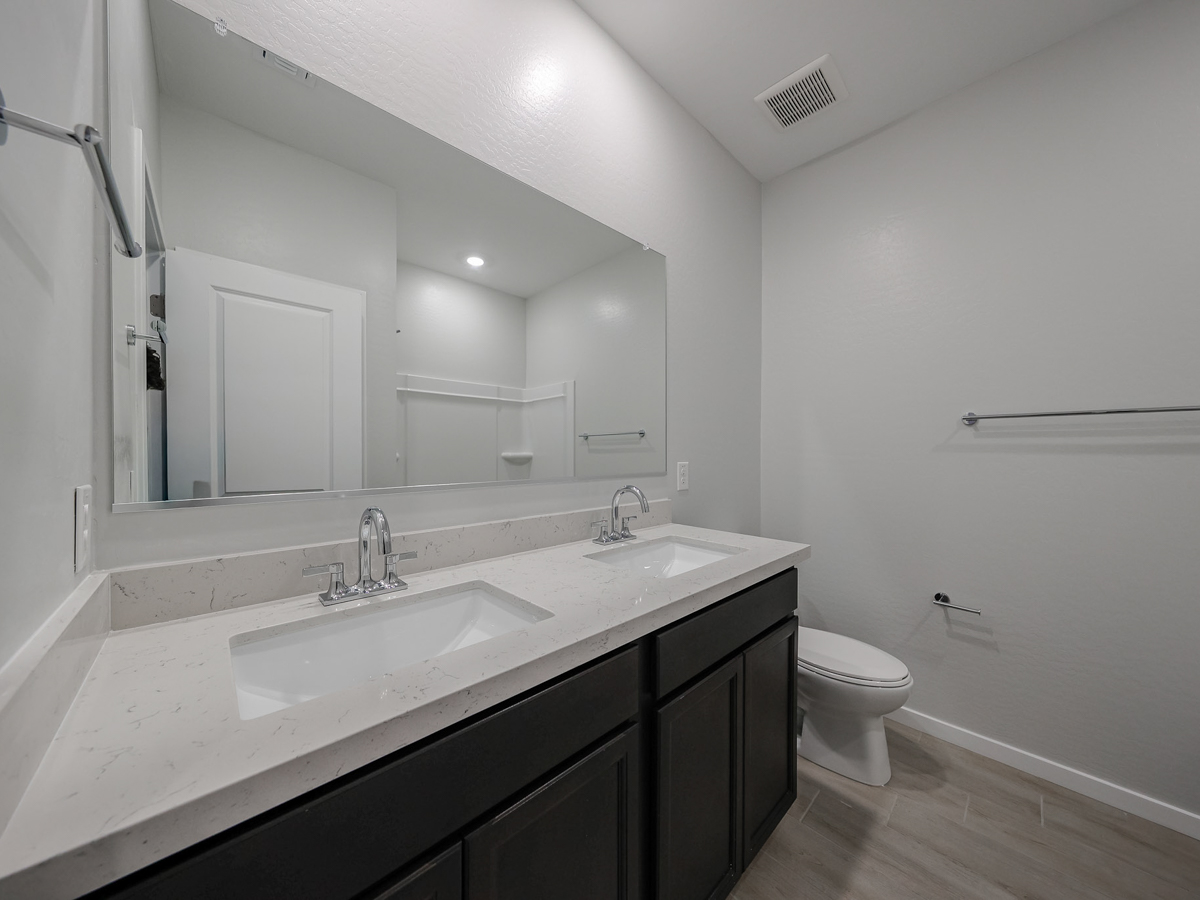 A bathroom with a sink and a toilet.