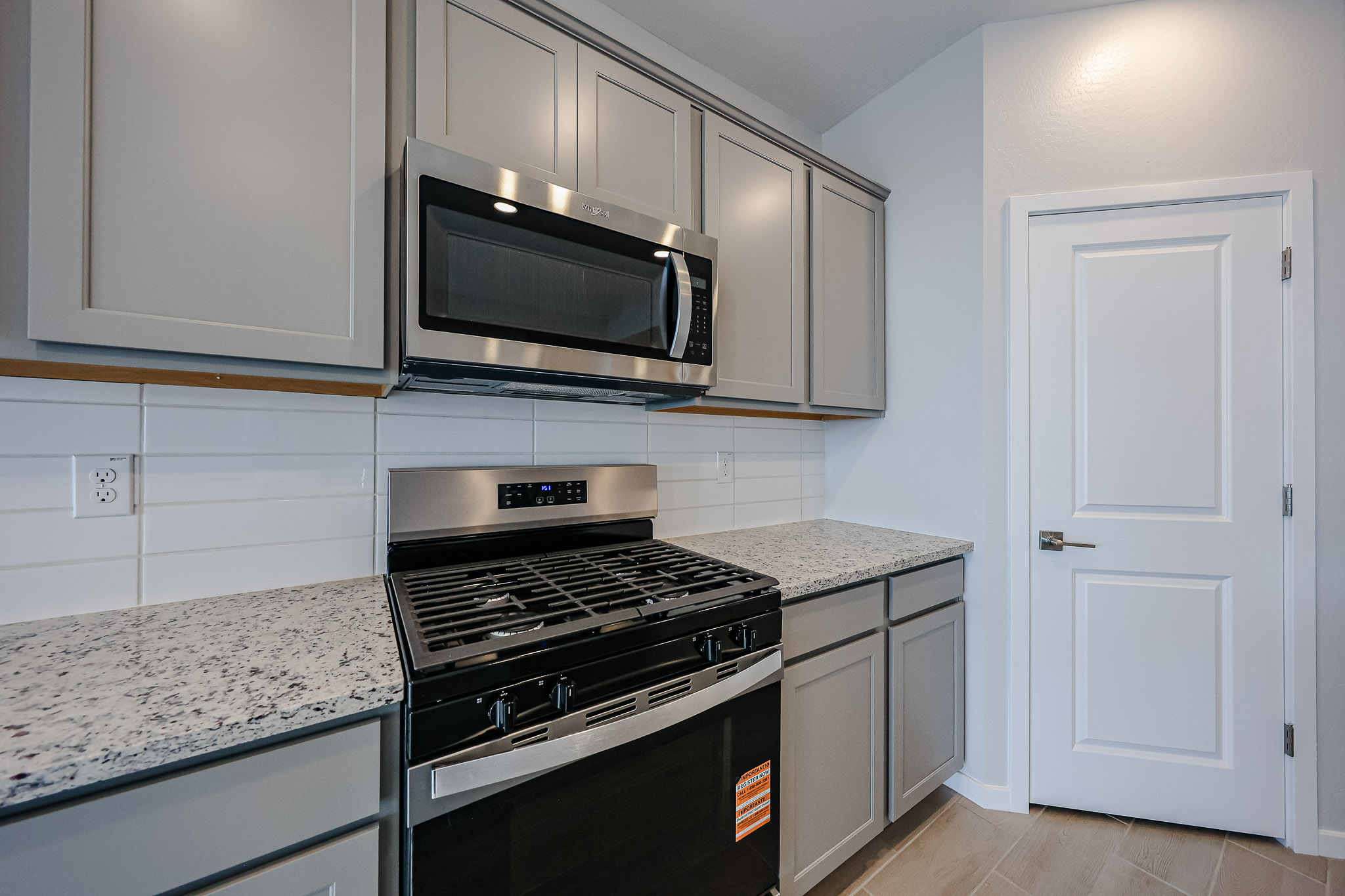 A kitchen with white cabinets.