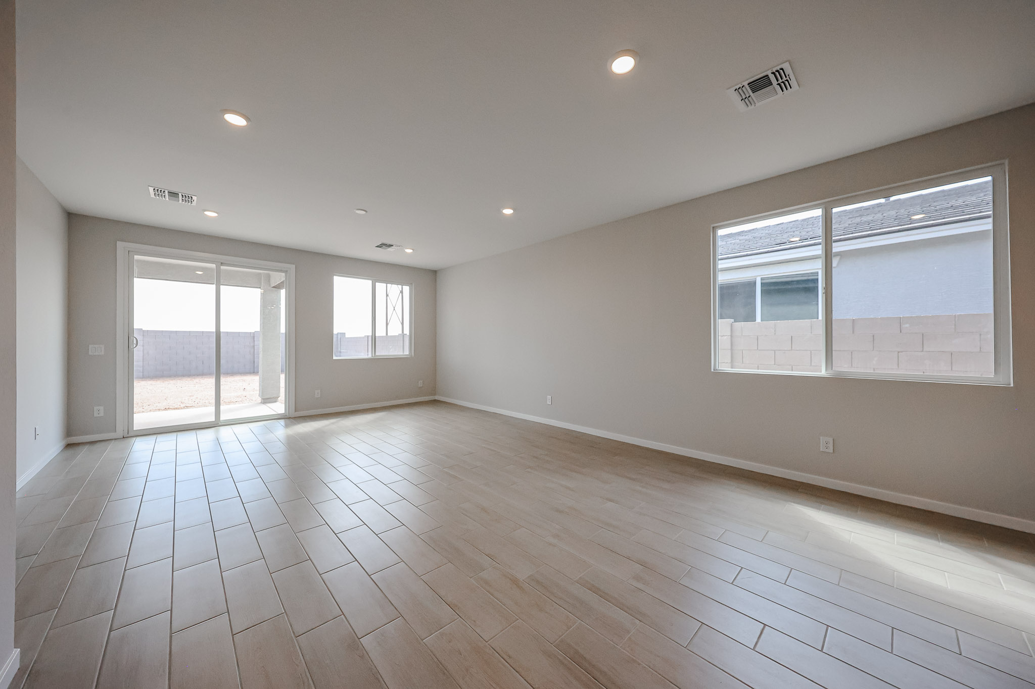 A room with windows and wood floors.