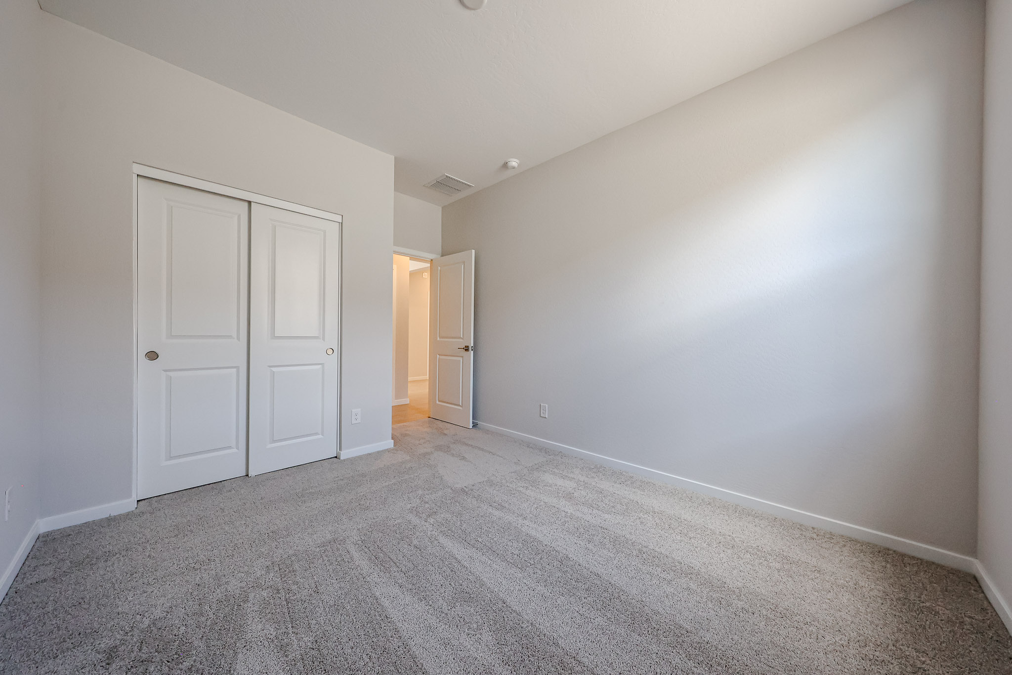 A hallway with white doors.