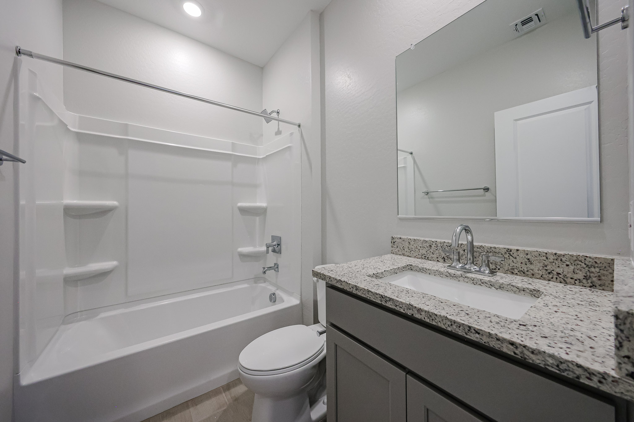 A bathroom with a marble countertop.