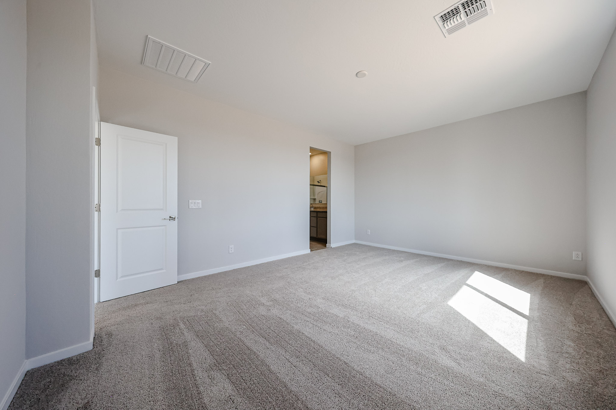 A hallway with white doors.