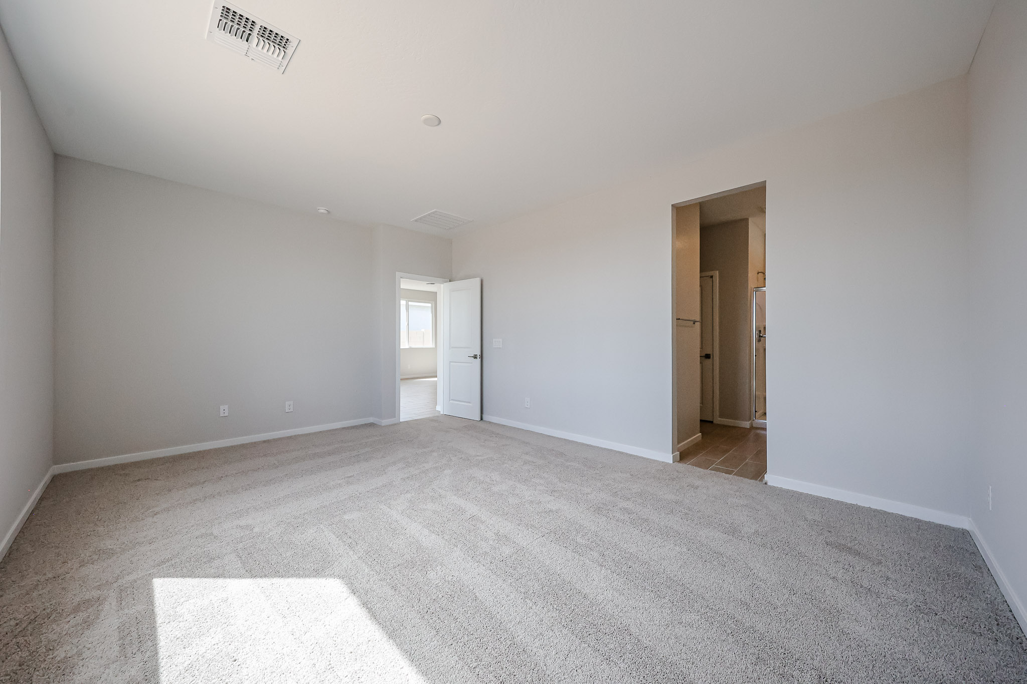 A hallway with white walls.