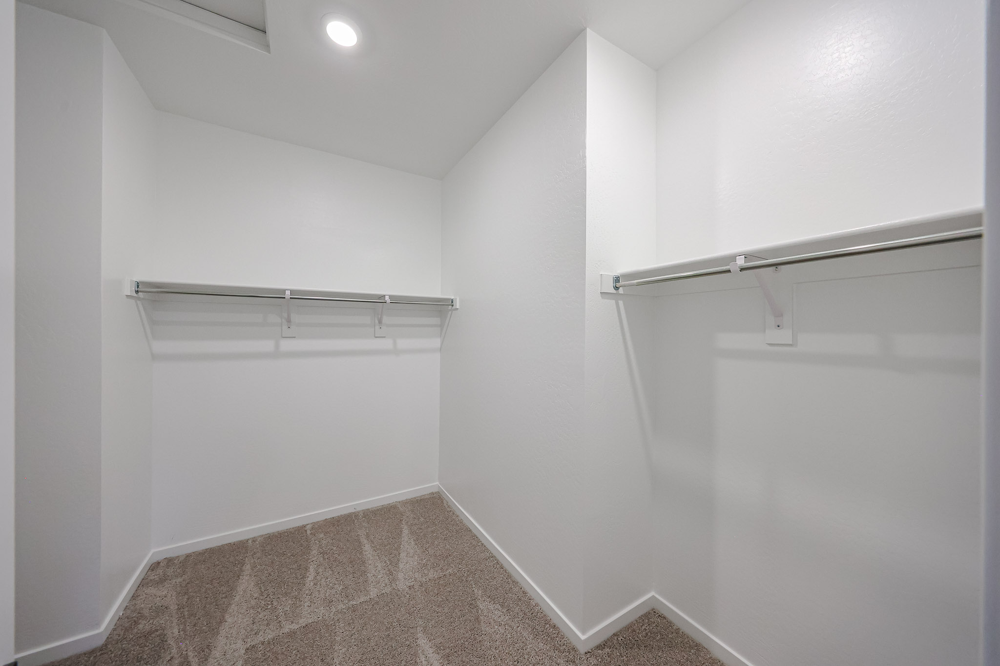 A white room with a metal bar.