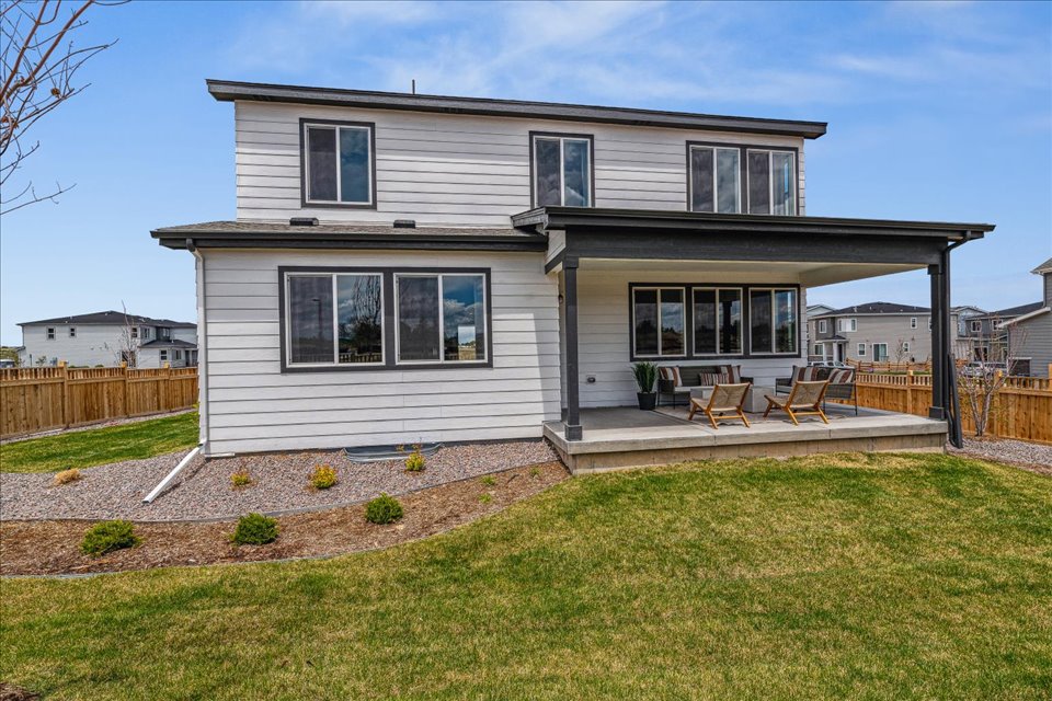 A house with a yard and a fence.