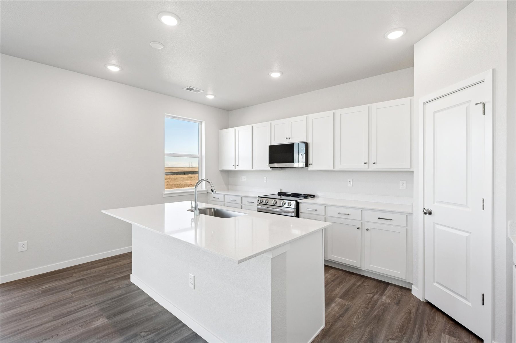 A kitchen with white cabinets.