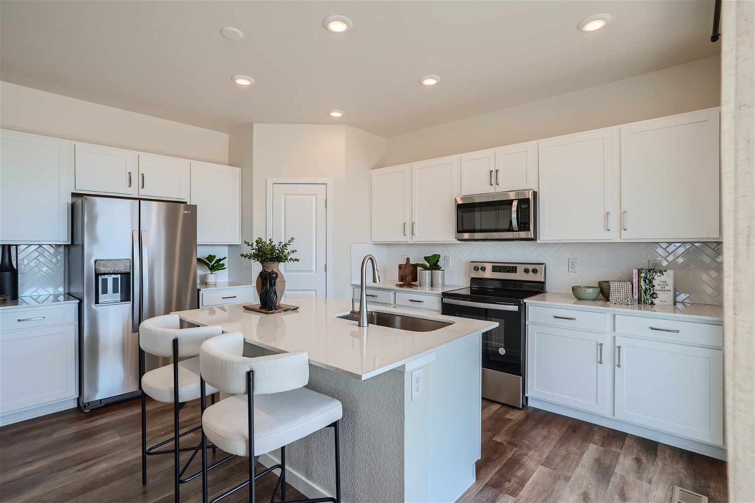 A kitchen with white cabinets.