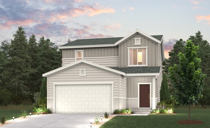 A house with a garage and trees around it.