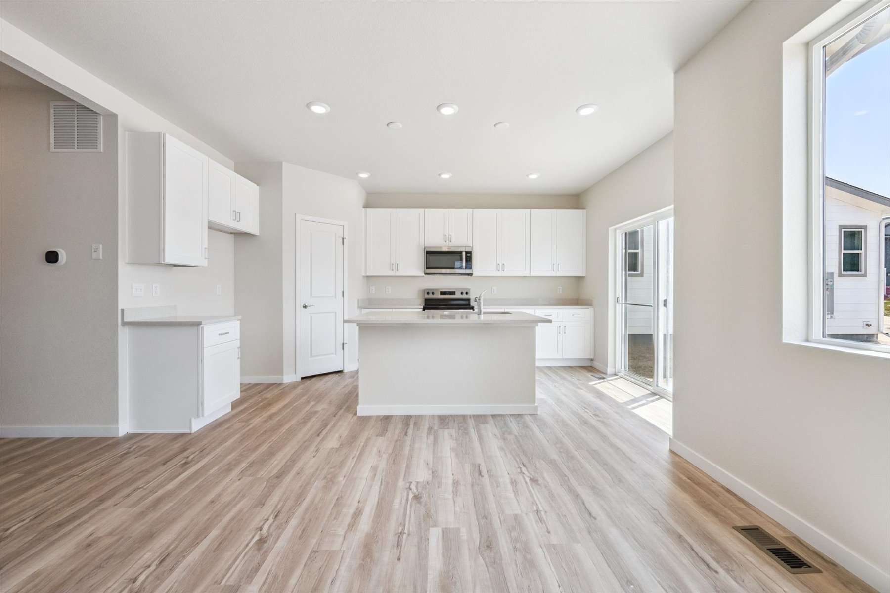 A large kitchen with white cabinets.