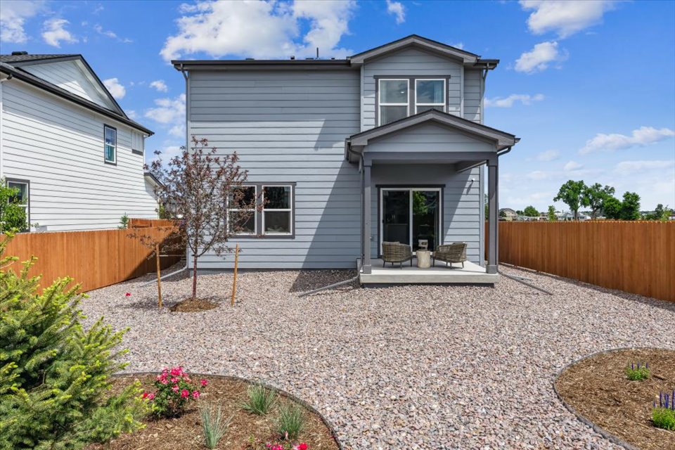 A house with a gravel driveway.