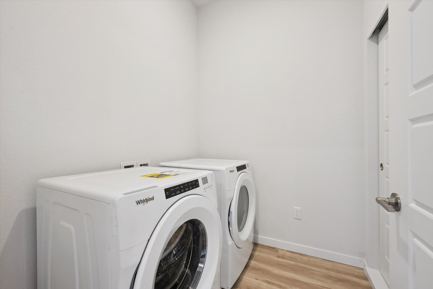 A white washing machine in a room.