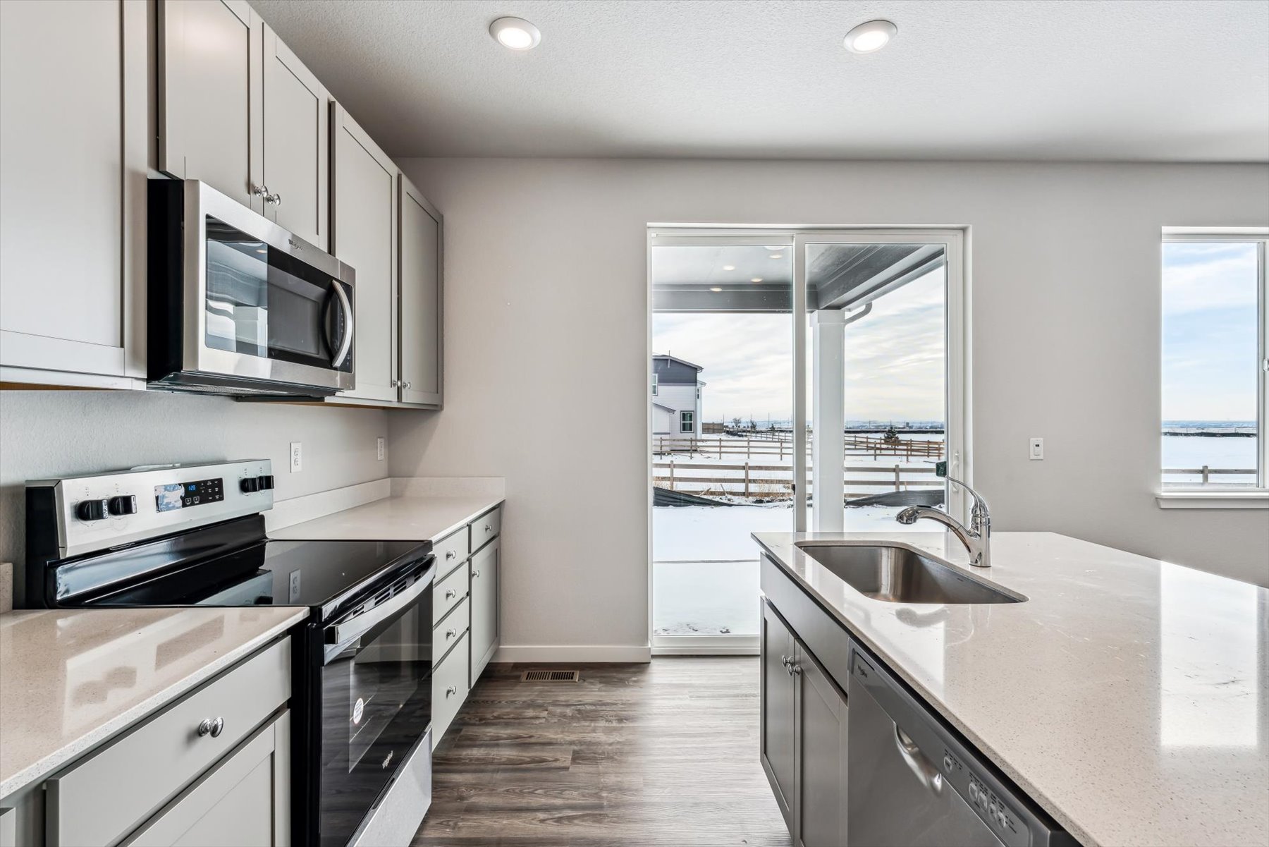 A kitchen with white cabinets.