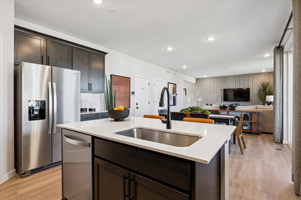 A kitchen with a stainless steel sink.
