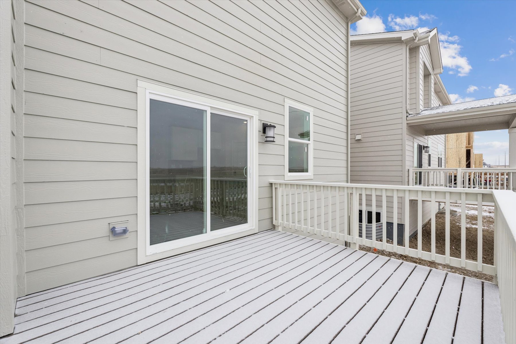 A white house with a deck.