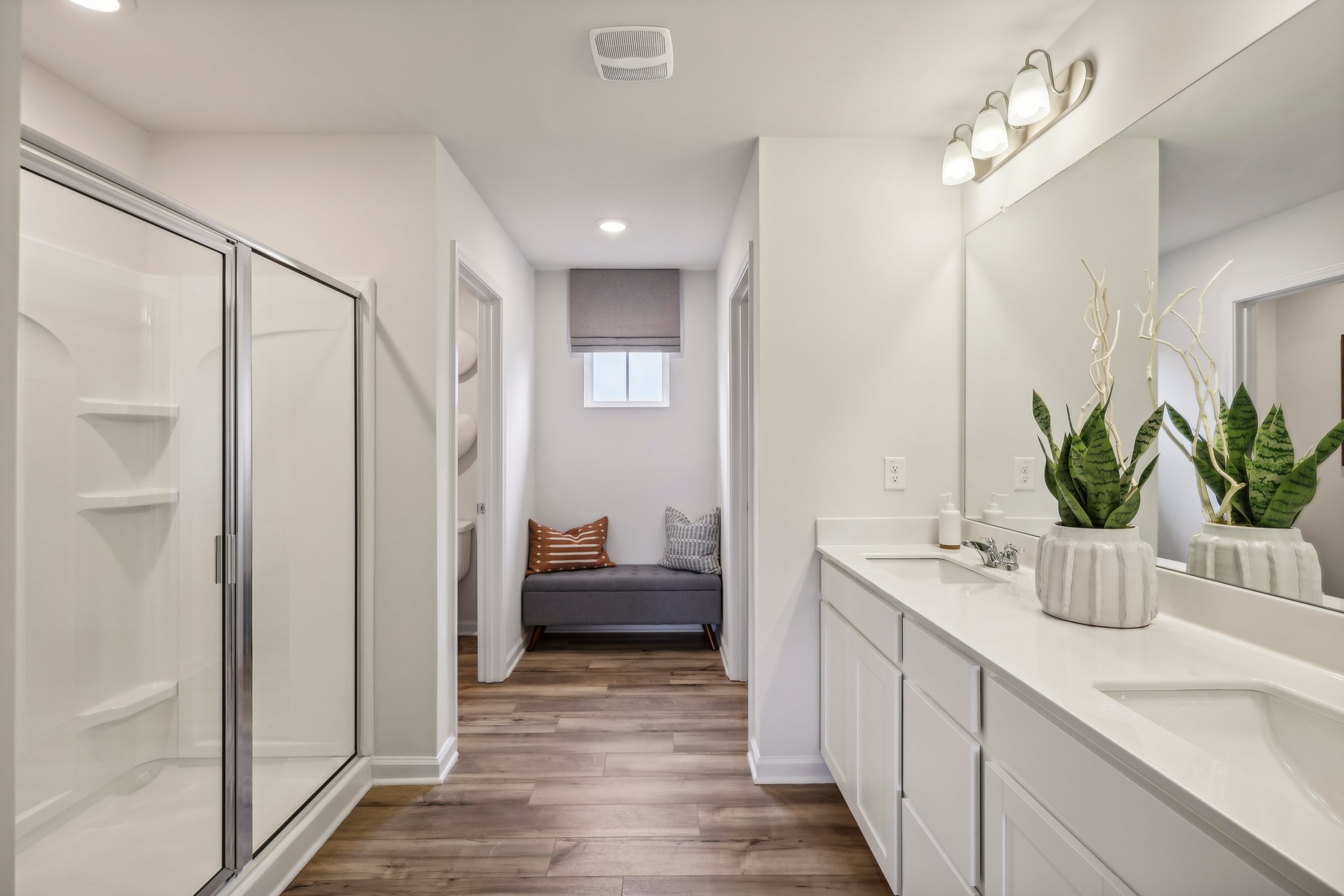 A bathroom with a tub and a bed.