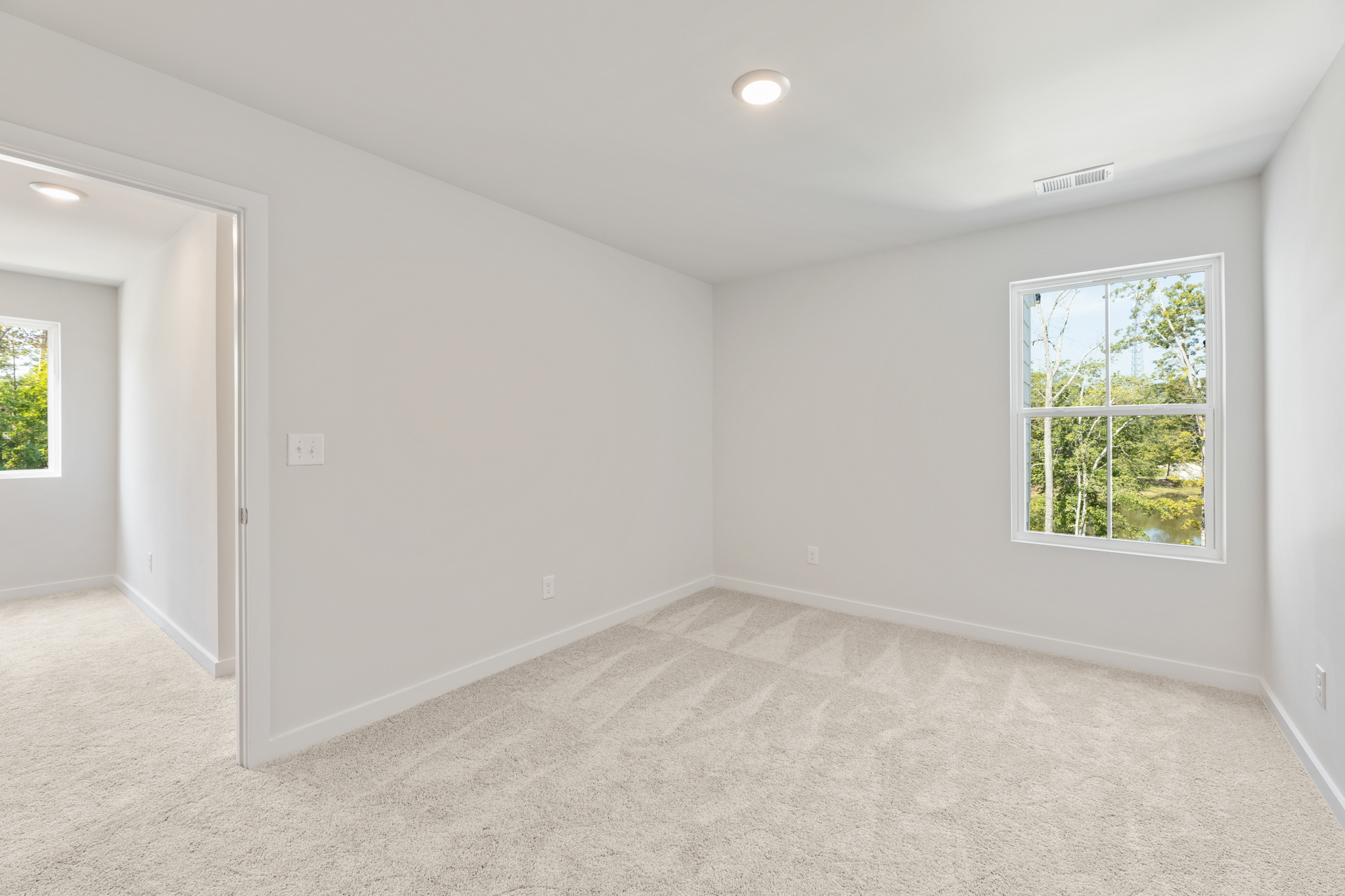 A room with a window and a door.