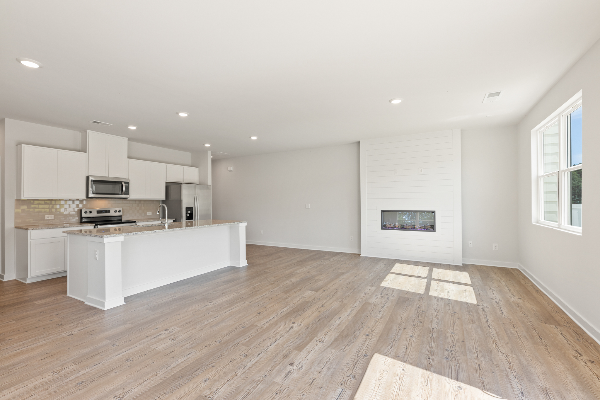 A kitchen with white cabinets.