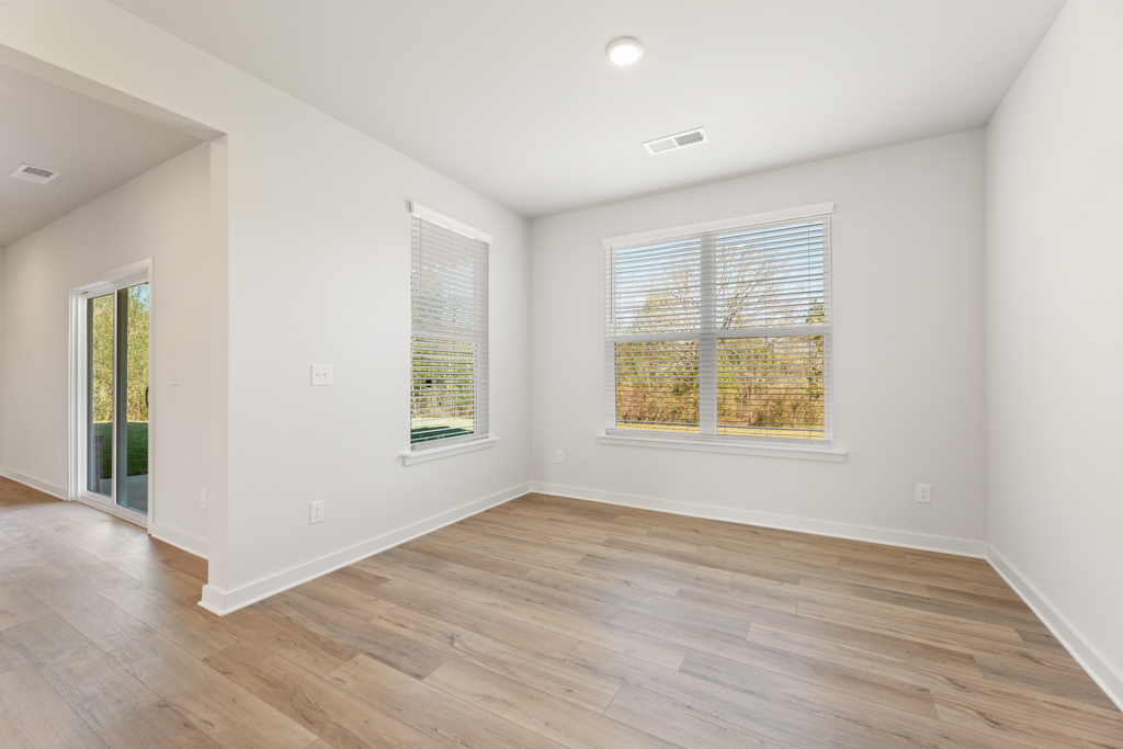 A room with a wood floor and a window.