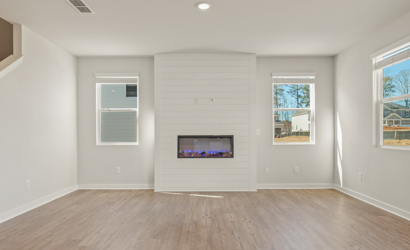 A room with a tv and windows.