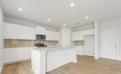 A kitchen with white cabinets.