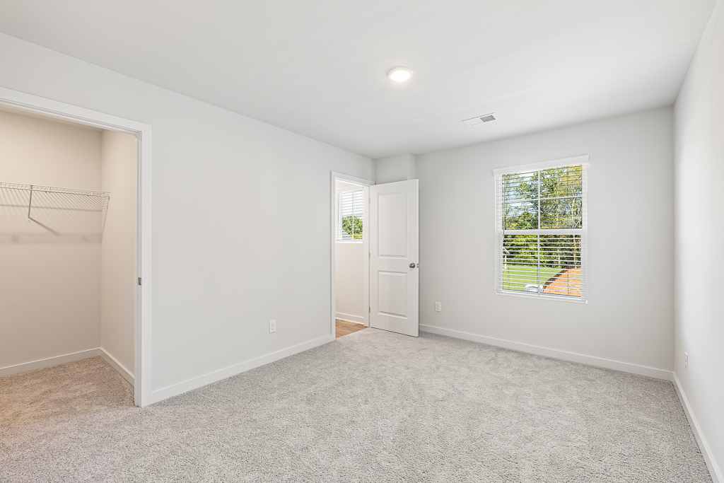 A room with white walls and a window.