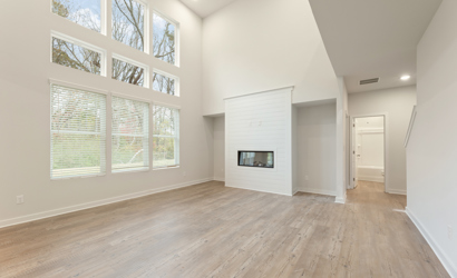 A room with a fireplace and a wood floor.