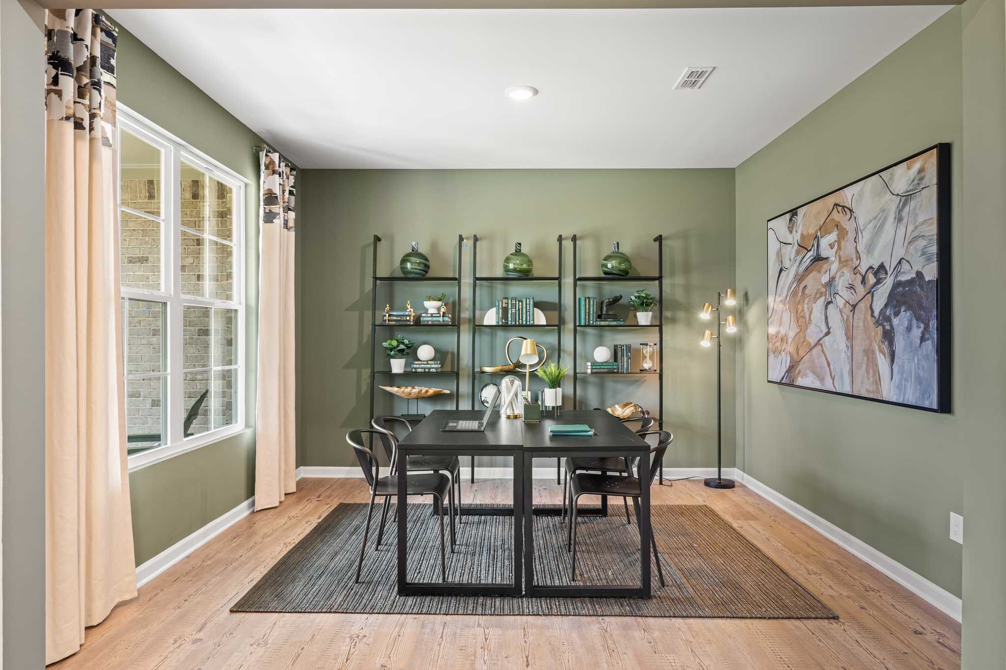 A dining room with a table and chairs.